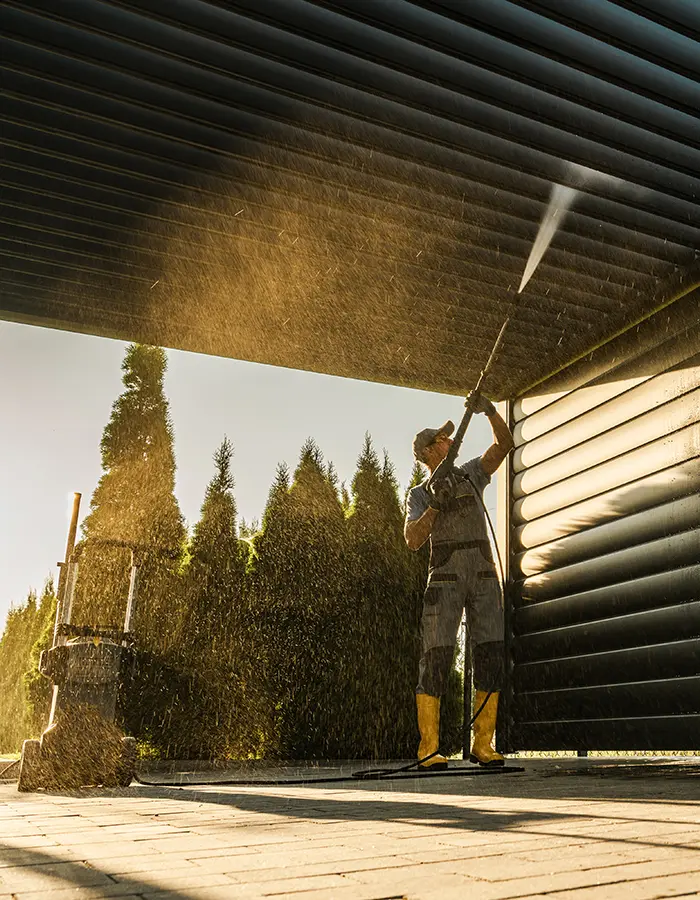 tradie pressure washing wooden slats